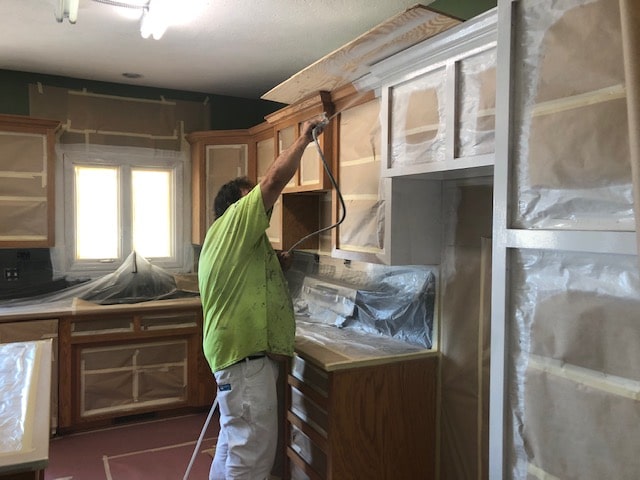 7 types of cabinet finishes. photo of cabinets being sprayed.