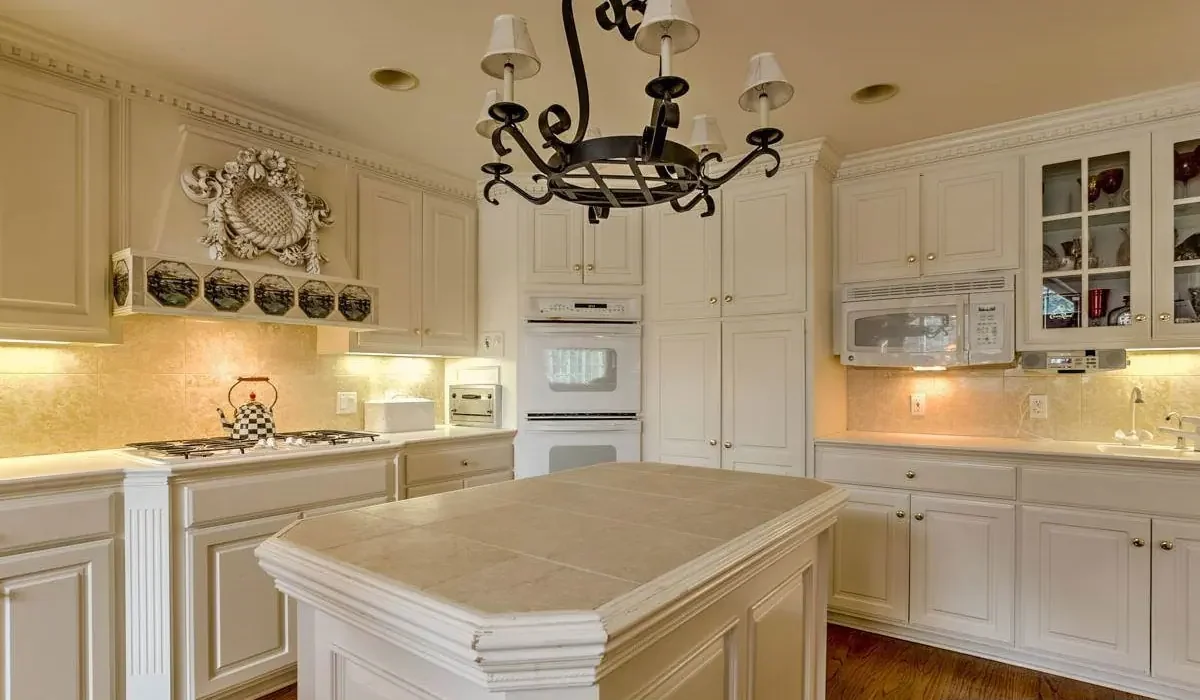 Kitchen with white painted cabinets and a center island, finished by The Painting Company